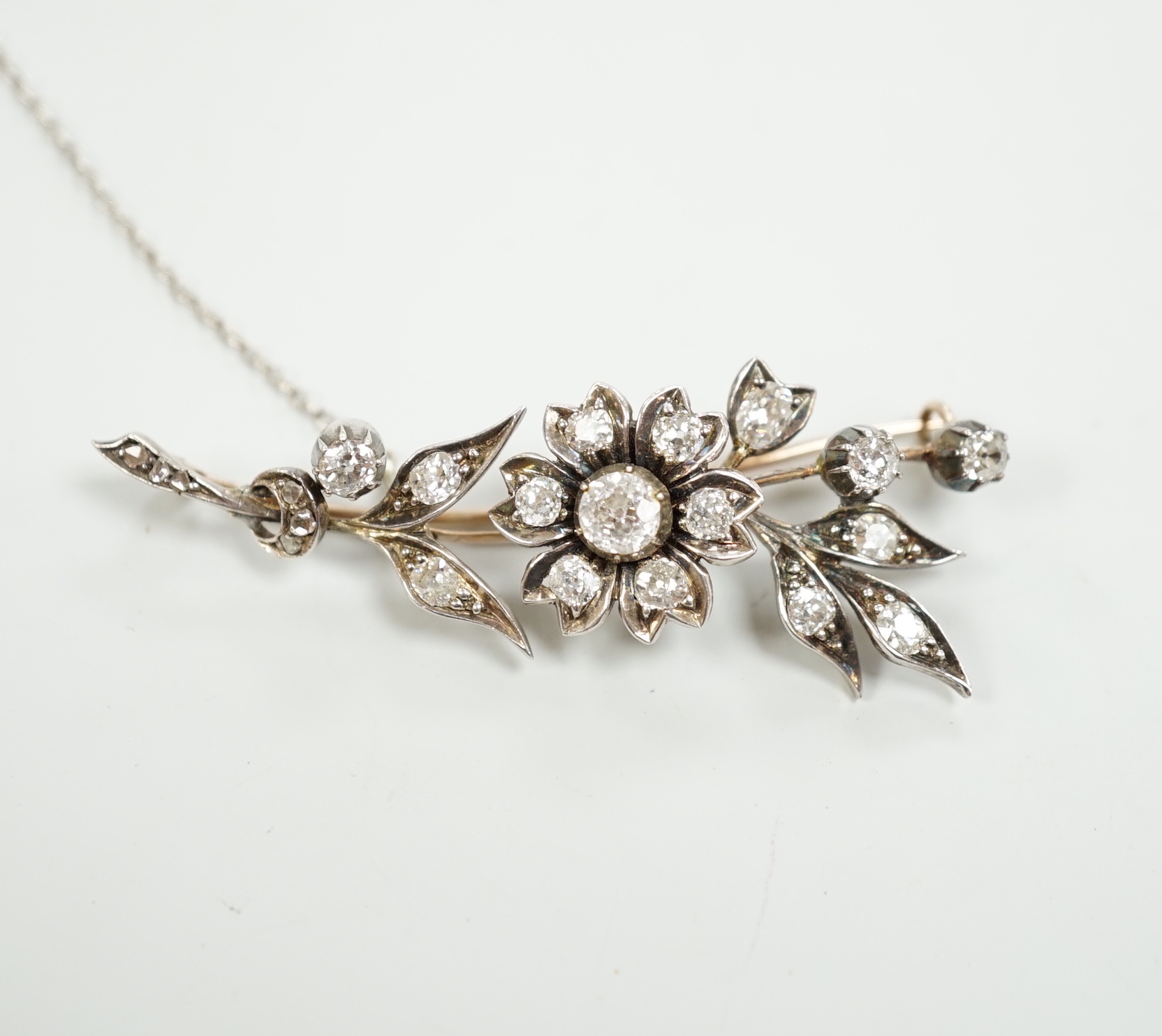 A Victorian yellow and white metal, diamond cluster set floral spray brooch, 56mm, gross weight 8.1 grams.